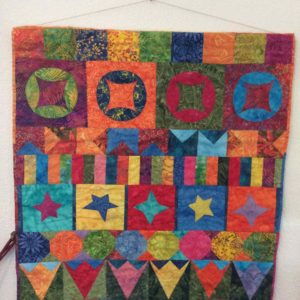 colourful quilt with stars and triangles